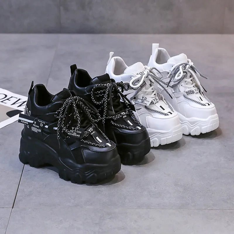 Women's white and black breathable mesh platform sports shoes with cross-strap and rubber sole.