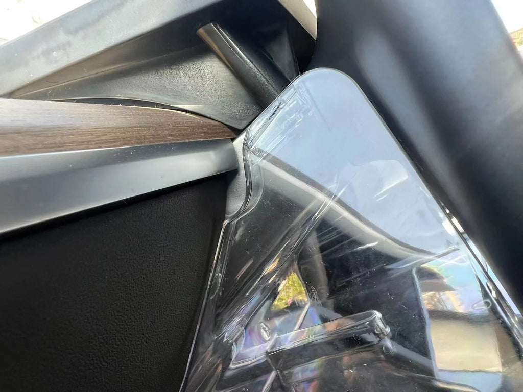 Black ABS plastic storage box fitted under the touchscreen of a Tesla Model Y interior.