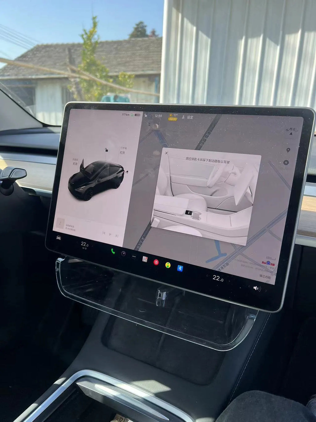 Black ABS plastic storage box fitted under the touchscreen of a Tesla Model Y interior.