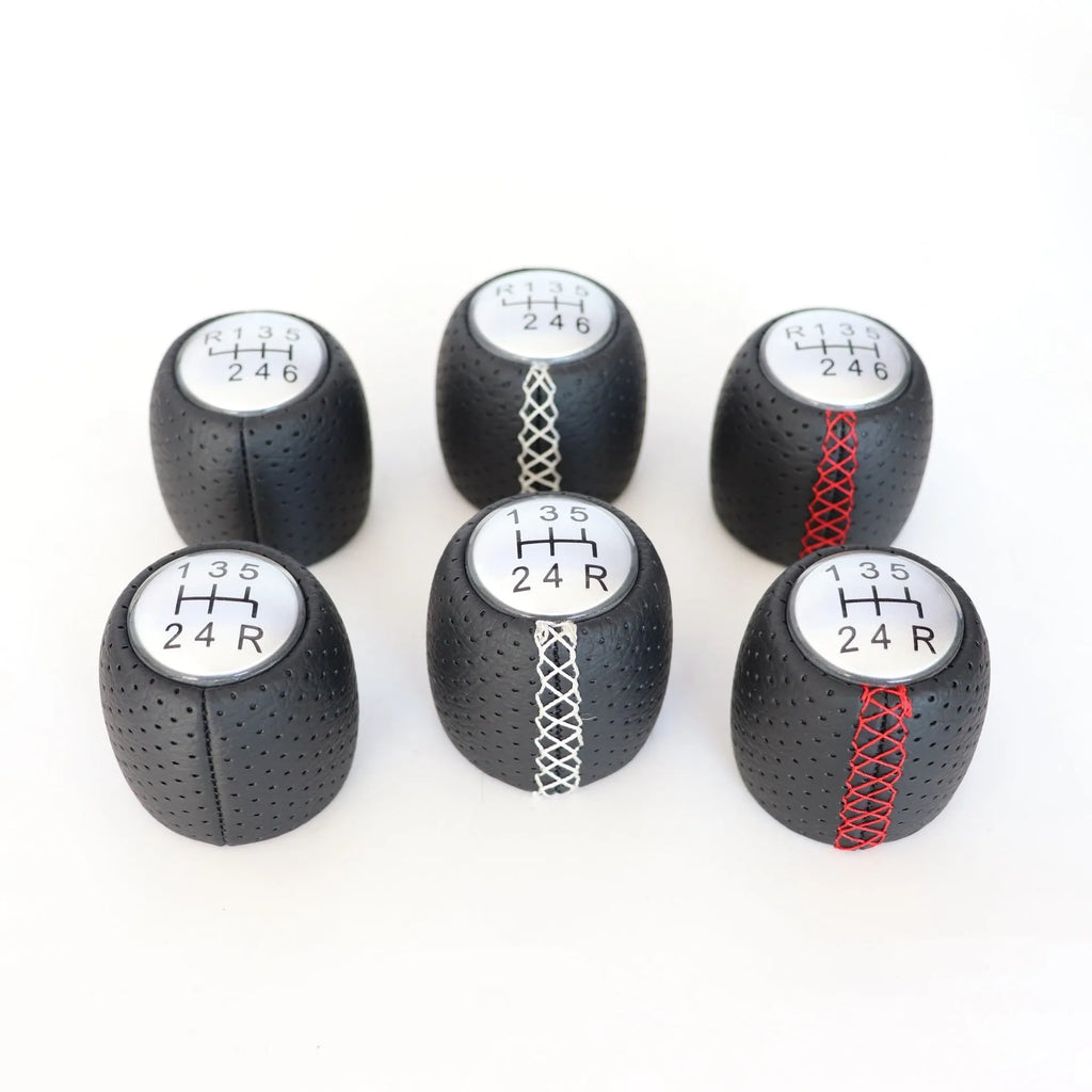 Sewn wrapped perforated leather gear knob for Alpha car in black, red, or white with matte or silver cover.