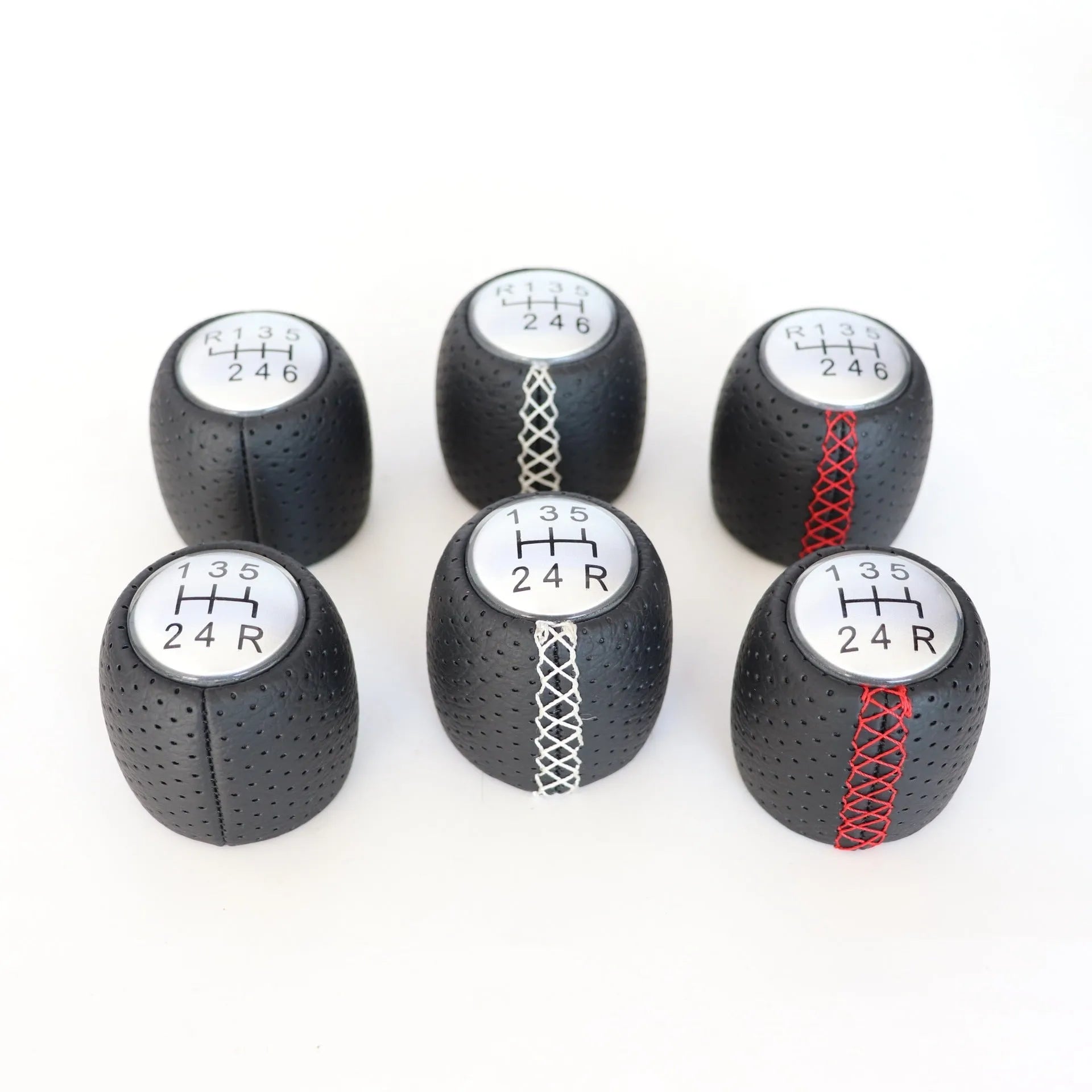 Sewn wrapped perforated leather gear knob for Alpha car in black, red, or white with matte or silver cover.