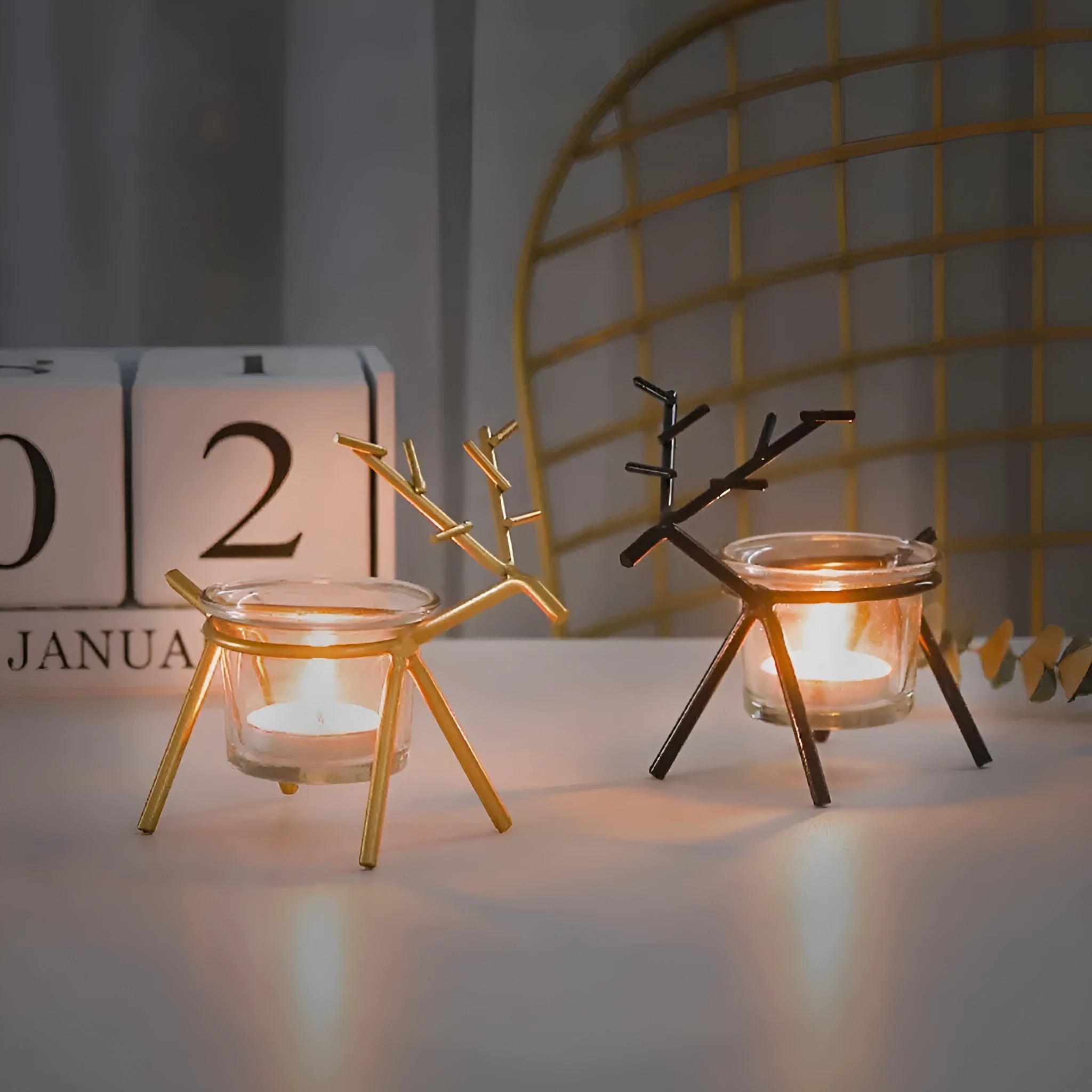 Wrought iron fawn candle holder with electroplated finish and glass cup in black colour