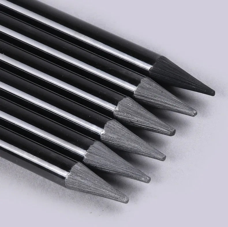 Set of nine graphite and carbonised drawing pencils in wooden casings on a suction card.