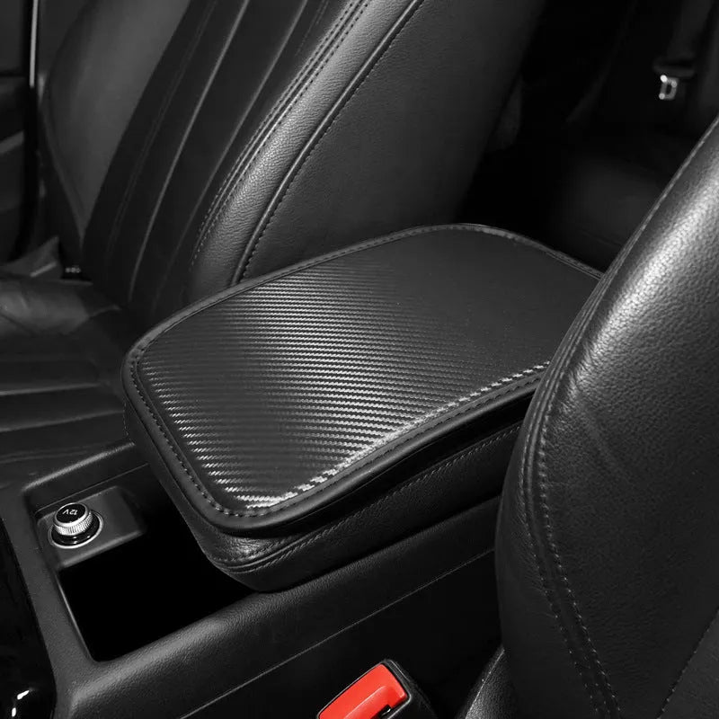 Leather car armrest box mat in black, shown on a car centre console.