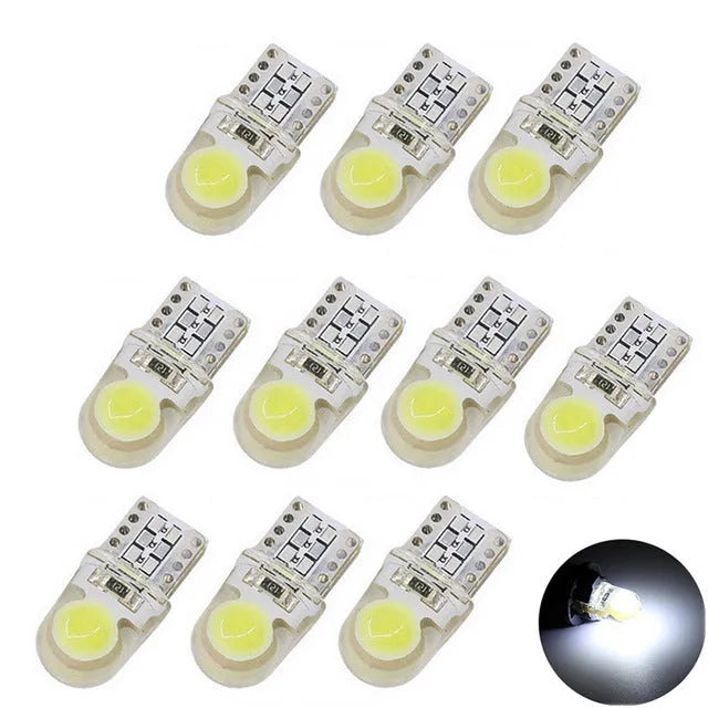 Ten T10 LED bulbs for cars in various colours including blue, red, and white, showing their 21.5mm length.