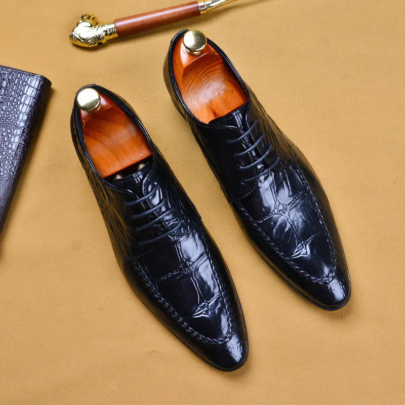 Men's black leather oxford shoes with a horse bit buckle and pointed toe on a rubber sole.