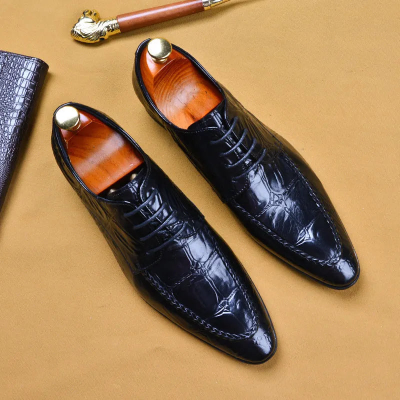 Men's black leather oxford shoes with a horse bit buckle and pointed toe on a rubber sole.