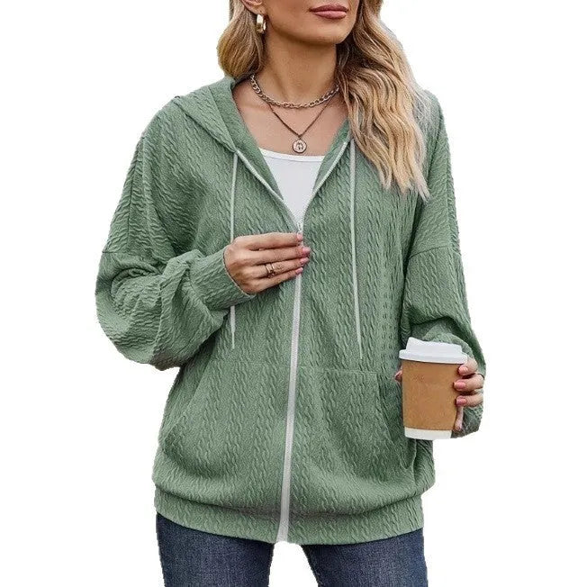 Green women's loose-fit zip-up hooded sweater coat on a hanger.