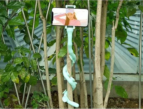 Flexible worm-style lazy bracket mobile phone holder with long silicone arm and black rubber suction cup base.