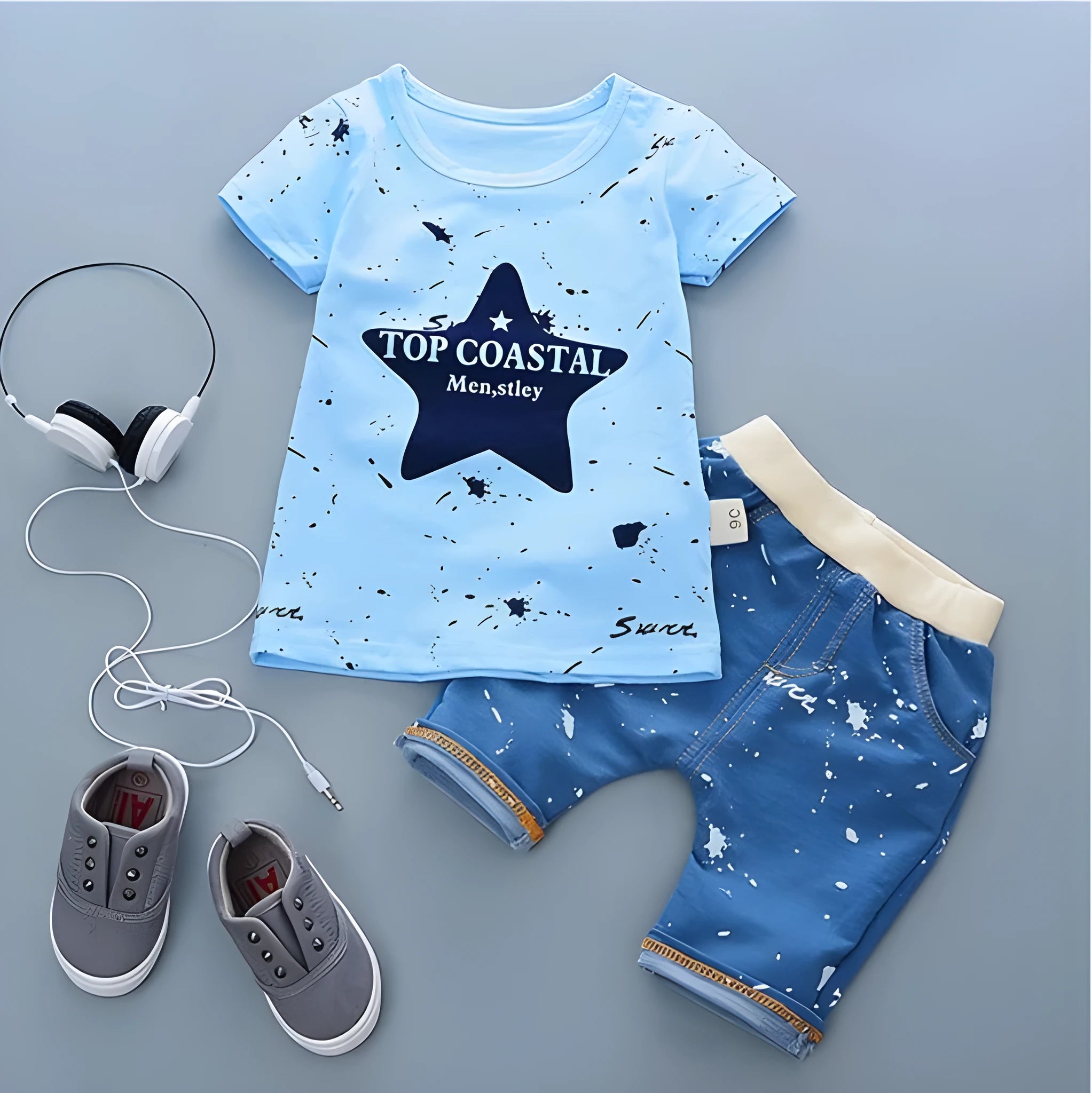 Baby boy wearing a blue crocodile print cotton t-shirt and matching blue shorts summer outfit set.