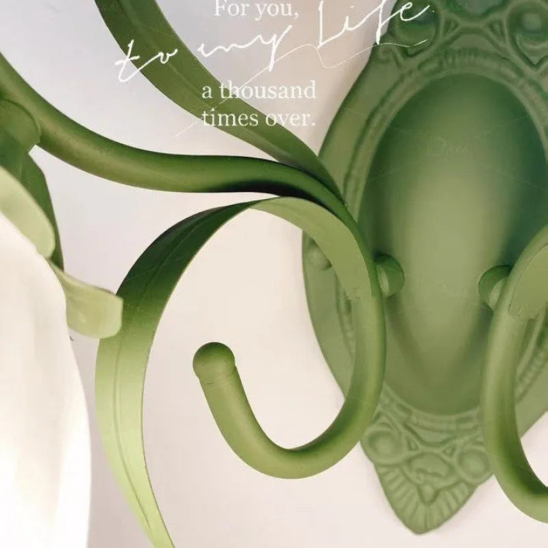 Green pastoral style flower-shaped wall lamp with a glass shade and integrated LED light.
