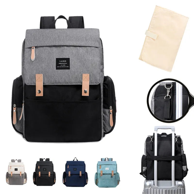 LAND Mommy large grey Oxford cloth diaper backpack with changing mat, shown on a table