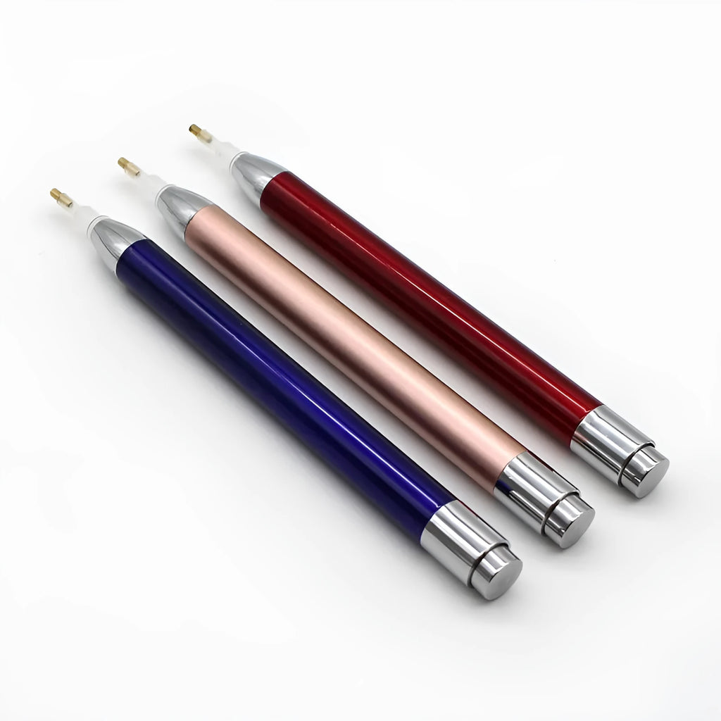 Blue luminous aluminium alloy drill pen for diamond painting and cross stitch crafts on a dark surface.