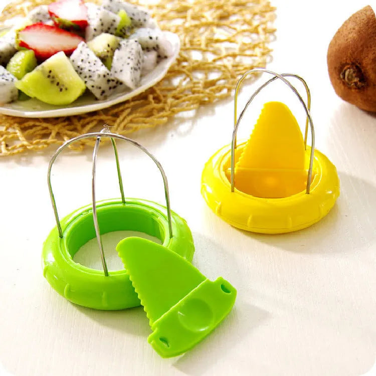 Mini kiwi fruit cutter peeler slicer on table showing compact size and stainless steel blade
