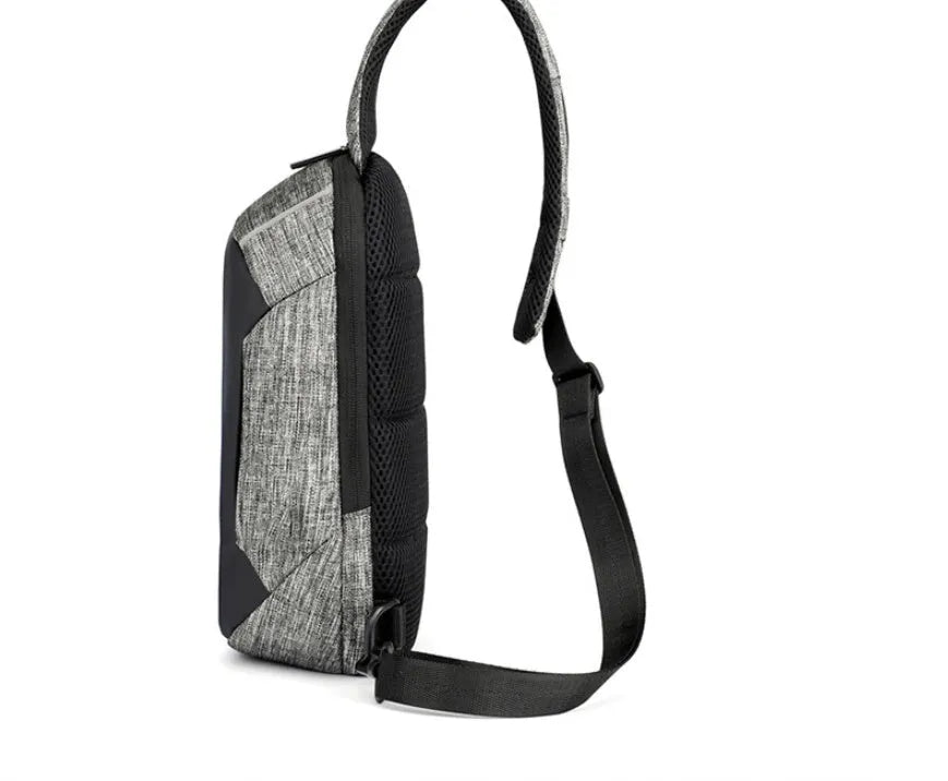 Small dark blue oxford cloth chest bag with a zipper and adjustable strap, showing internal phone pocket.