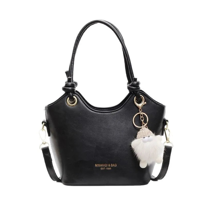 Small square PU crossbody bag in solid colour with zipper closure and single shoulder strap