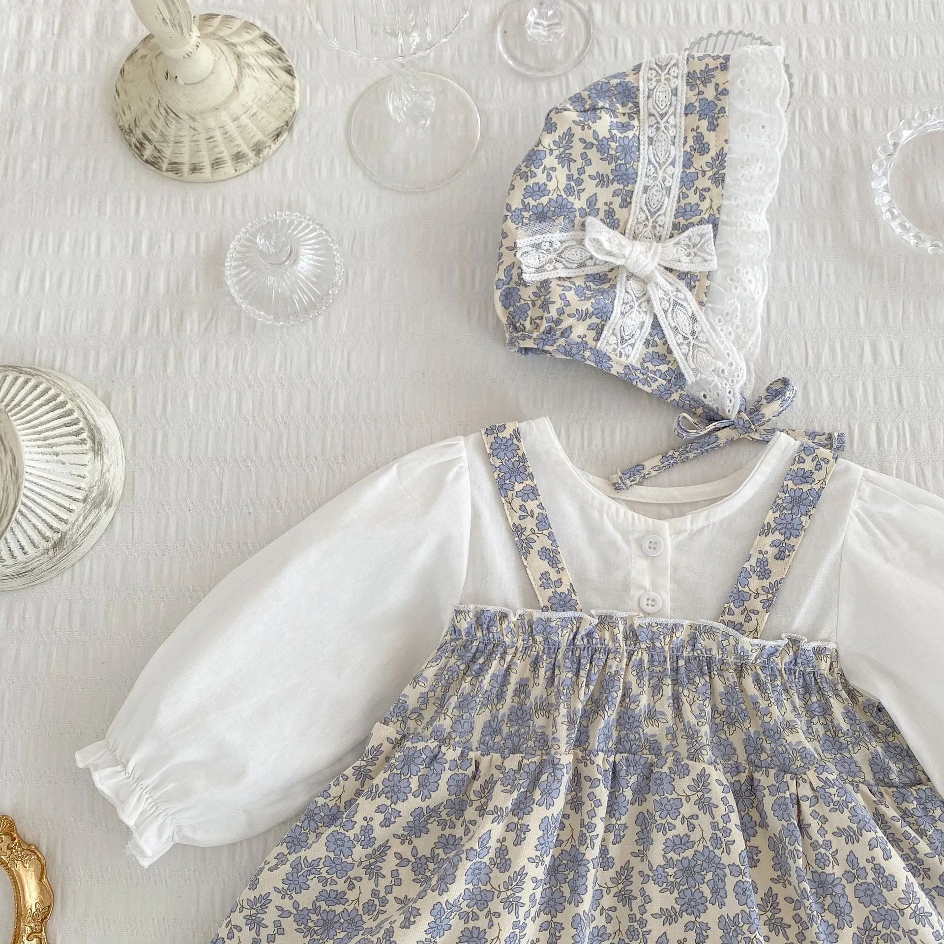 White cotton baby girl floral princess fake two triangle romper with removable hood, long sleeves, front view