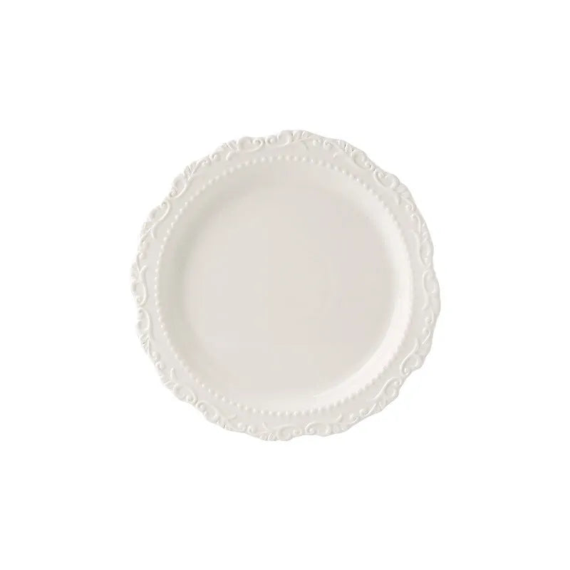Cream ceramic vintage lace plate with irregular shape and glazed finish in white