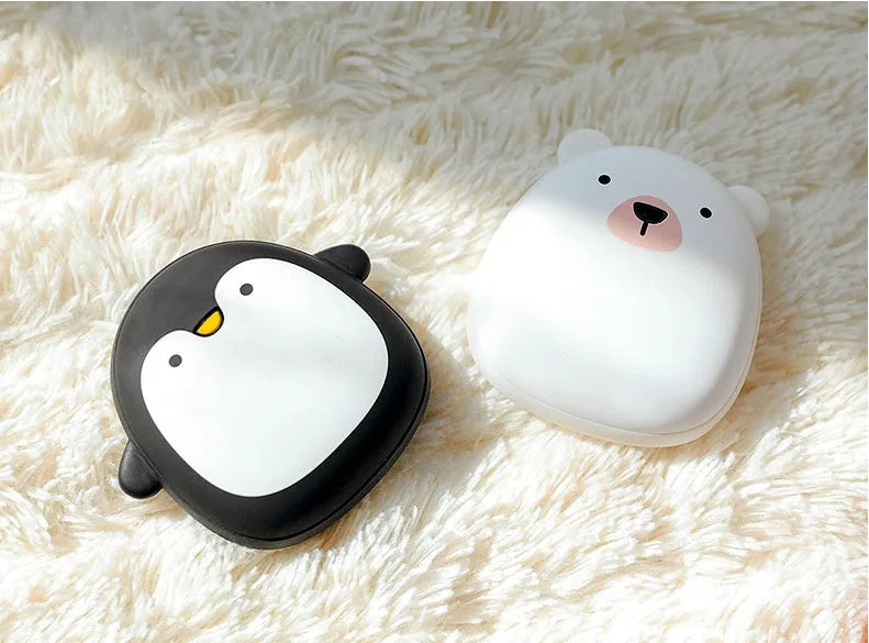 Cute cartoon penguin and polar bear design USB rechargeable hand warmer and power bank unit.