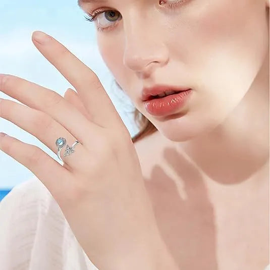 Rotating moonstone ring bracelet in white gold colour with adjustable opening and geometric circle and triangle design