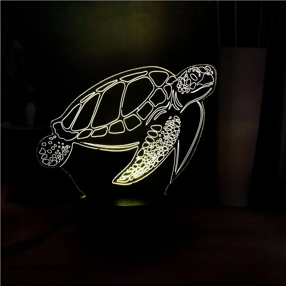 3D acrylic turtle-shaped LED night light glowing in blue, with a remote control.