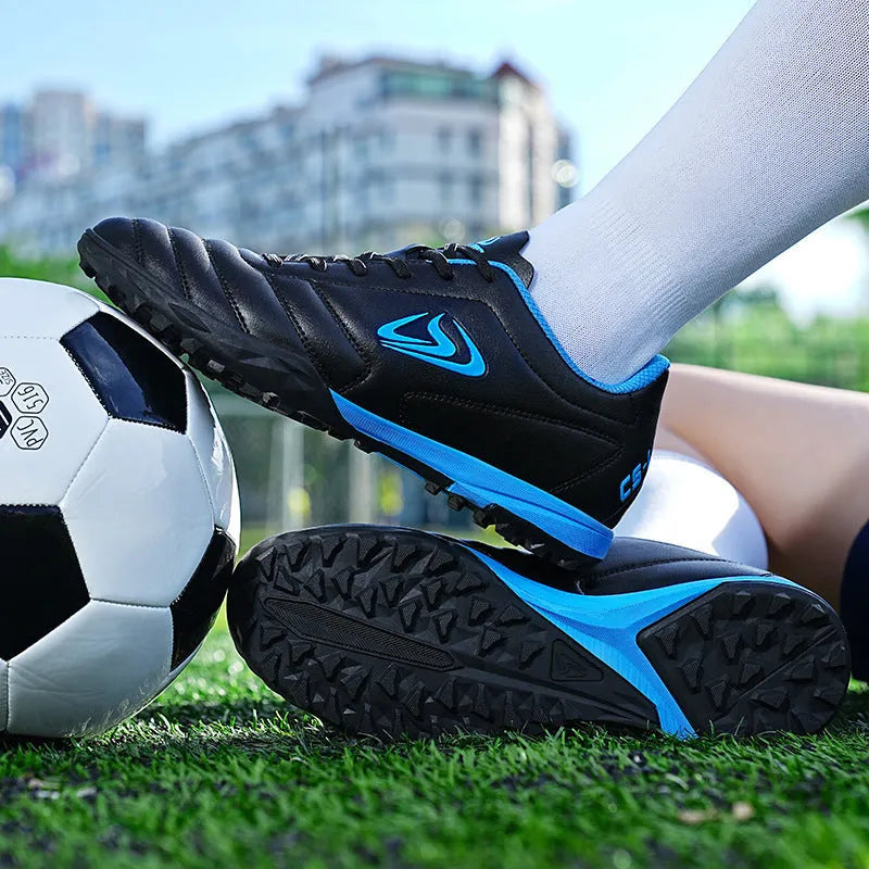 Men's outdoor football boots with synthetic leather upper and non-slip rubber sole for artificial grass