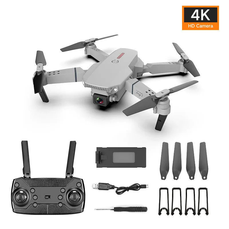 Grey foldable 4K dual camera drone with remote controller on a table.