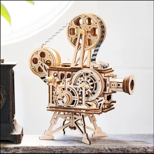 Wooden three-dimensional puzzle film projector with hand crank and gear wheel assembly