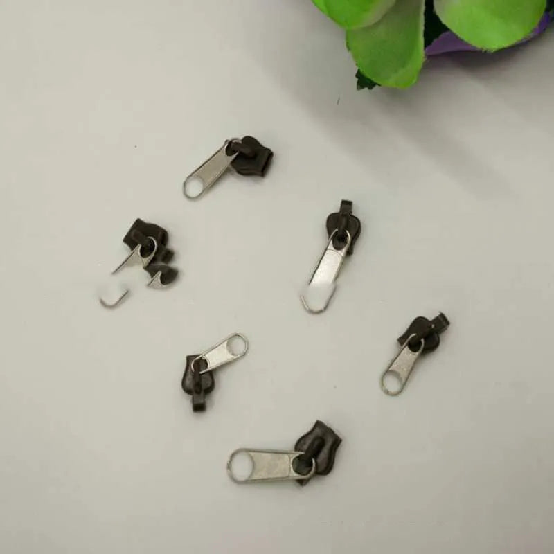 Reusable zipper head repair kit with 12 plastic and metal sliders in black, black grey, and coffee brown colours