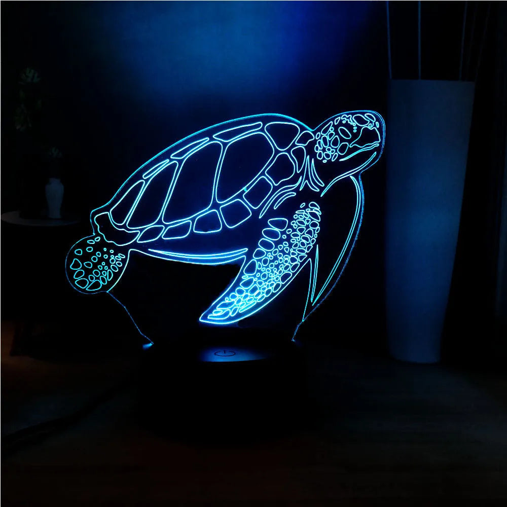 3D acrylic turtle-shaped LED night light glowing in blue, with a remote control.
