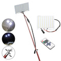 White LED fishing rod light unit on a tall telescopic pole with a remote control for outdoor use.