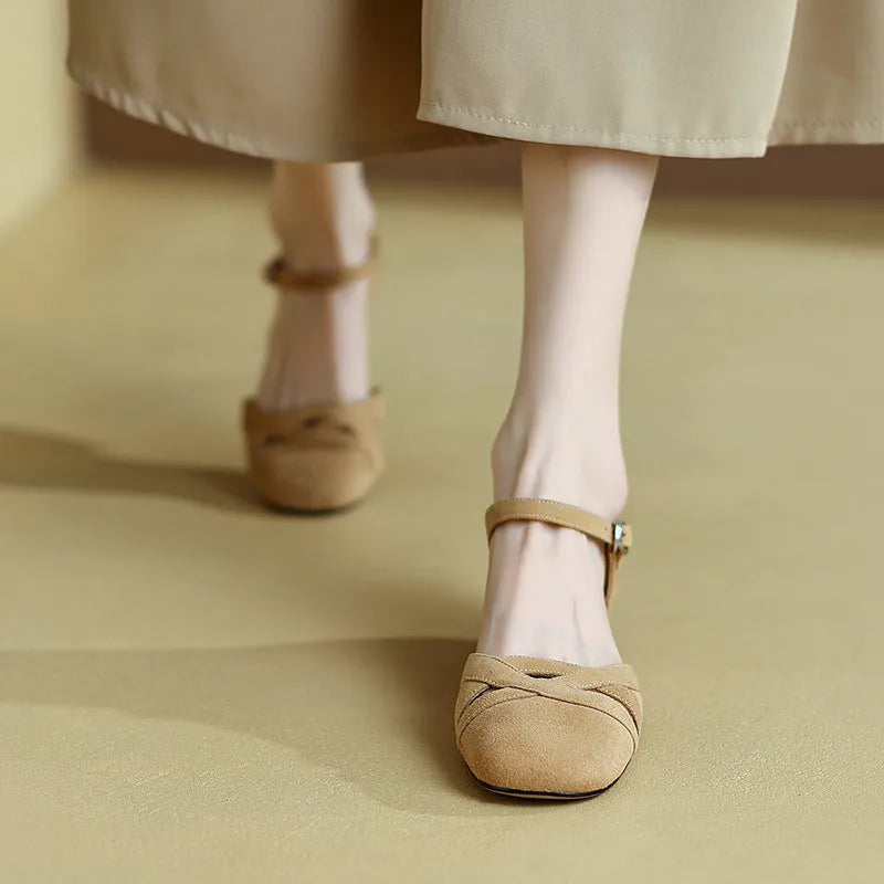 Apricot and green retro Roman sandals with a buckle strap and round toe on a rubber sole.