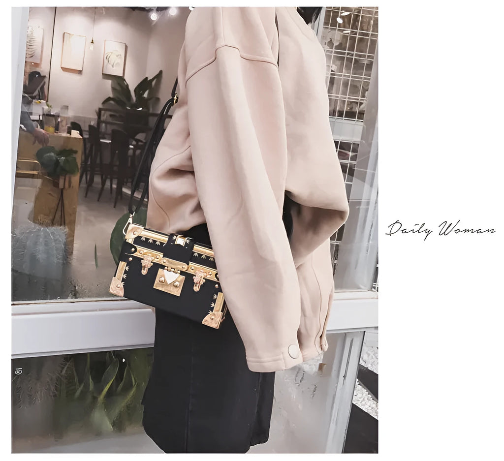Hard black PU women's shoulder handbag with flap, hasp closure, and decorative rivets.