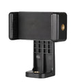 Black plastic single phone holder with rotating clamp on a wooden desk.