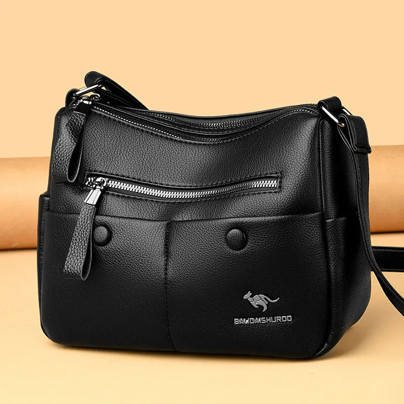 Soft PU leather crossbody shoulder bag in horizontal square shape with stitching details and multiple compartments