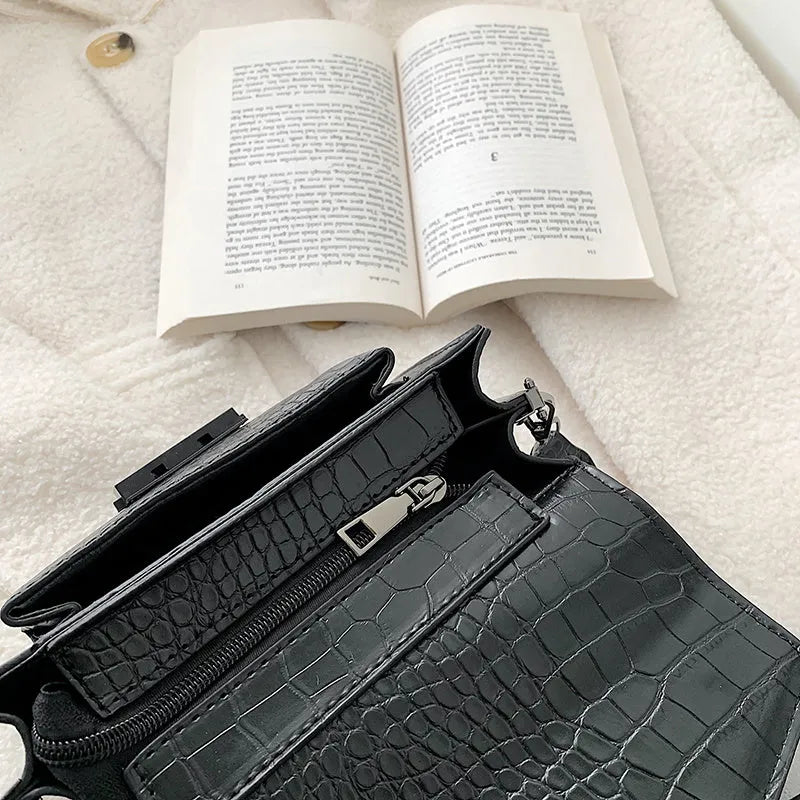Vintage-style black PU crossbody bag with adjustable strap showing interior