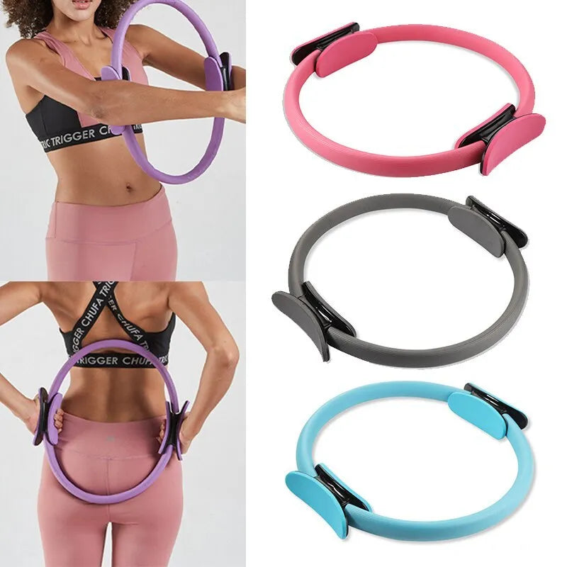 Pink pilates ring with ergonomic design on white background for yoga and home workout resistance training