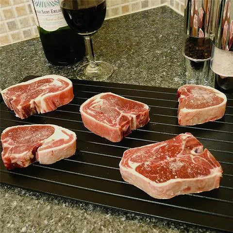Black aluminium quick defrosting tray for thawing frozen meat and food without electricity.