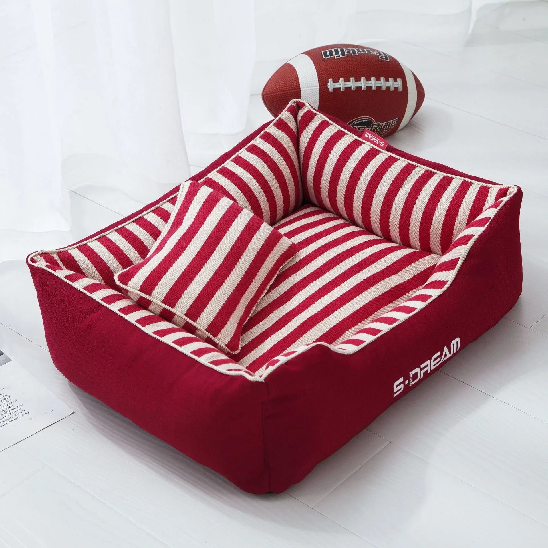 Navy stripes removable dog kennel mat and matching mini pillow set on a wooden floor
