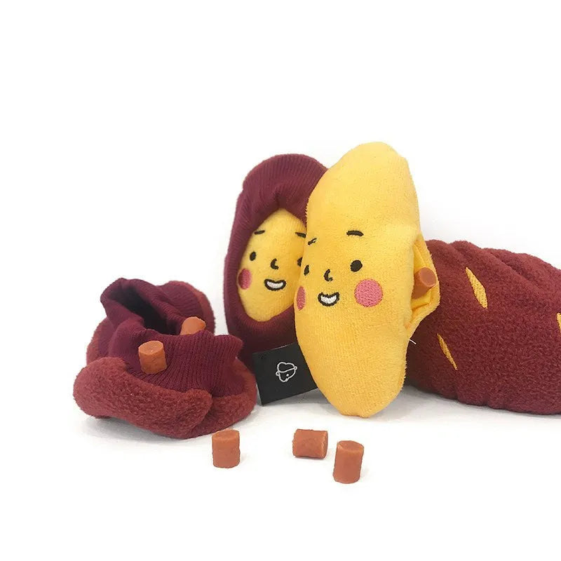 Red sweet potato-shaped dog puzzle toy with peel-open design revealing hidden treat compartments