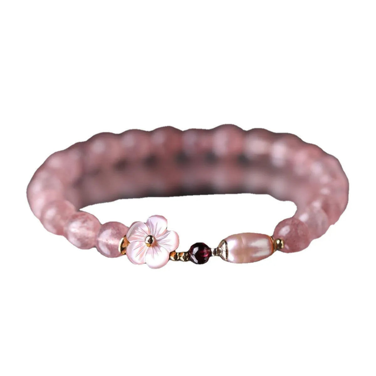 Women's strawberry quartz crystal bracelet with peach blossom flower bead design on wrist