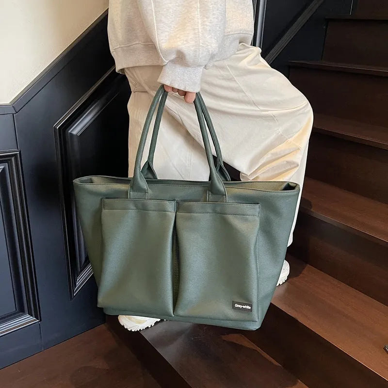 Sporty green PU shoulder bag with adjustable straps showing expandable compartments.