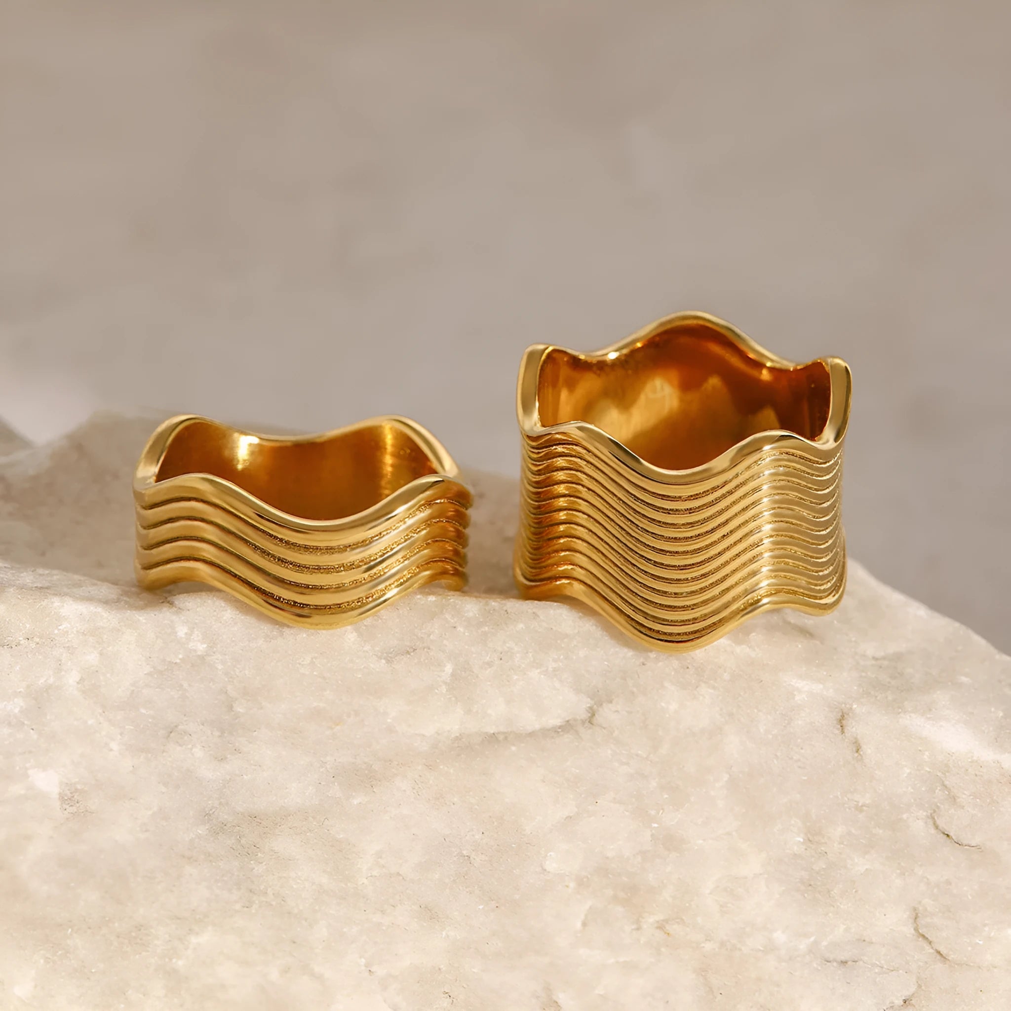 Stainless steel wide geometric wave ring with Korean style electroplated finish.
