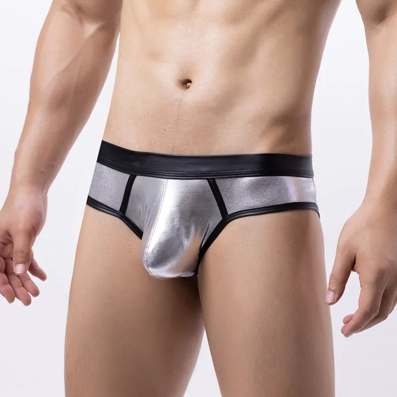 Men's gold patent leather polyester bikini swim briefs on a plain background