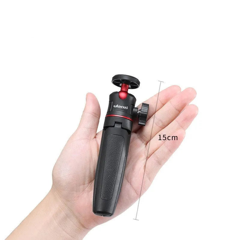 Black and red compact desktop tripod holding a smartphone, with flexible arm extended.