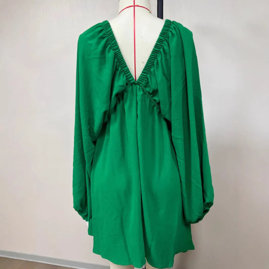 Women's v-neck long sleeve dress with puff sleeves and a flounced swing skirt in polyester fabric.