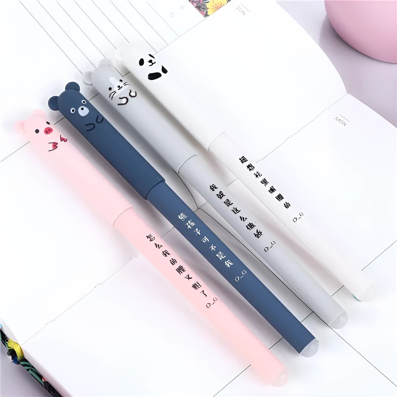 0.5mm hot erasable pen sets in black, blue, and red with refills and nibs on a desk