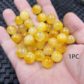 Handmade quartz rock jade bead in Topaz colour with pearlescent finish on white background