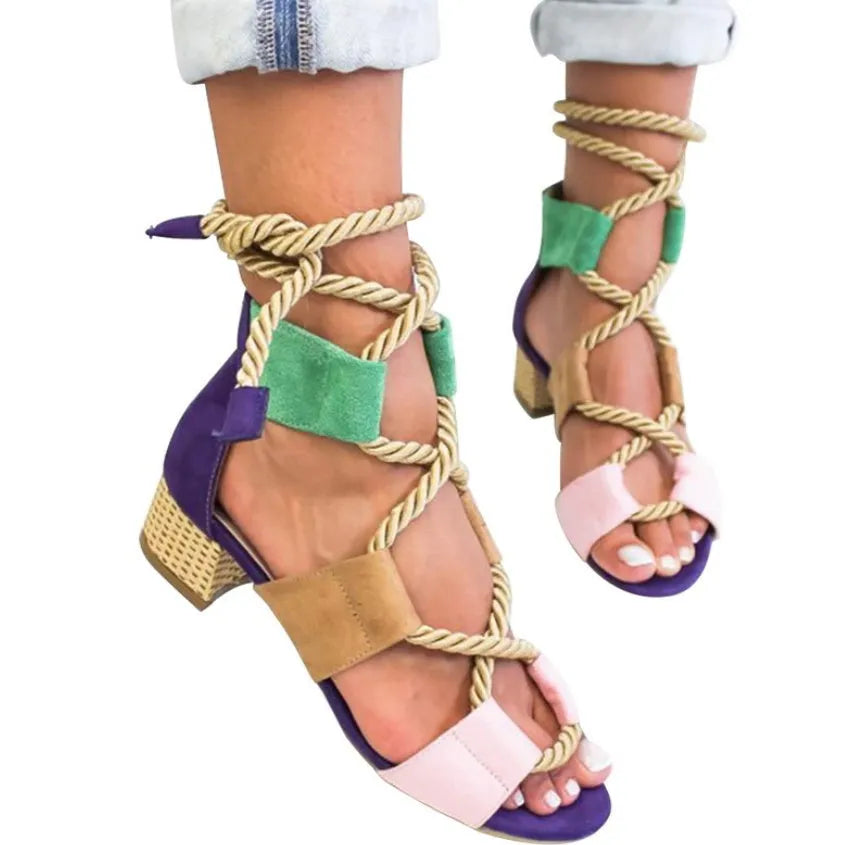 Women's beige suede sandals with a thick middle heel, front strap, and ankle strap, showing a round fish mouth toe.