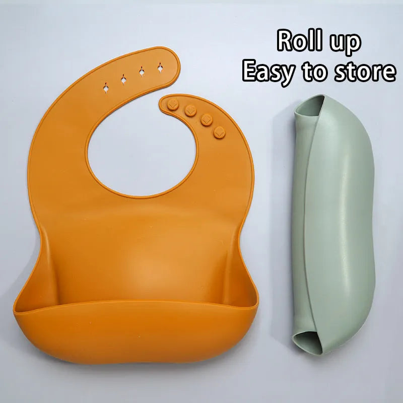 Soft waterproof silicone baby bib with food catcher in pink, with adjustable neck closure